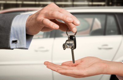 person handing keys to new car